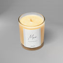 Bougie parfumée artisanale suisse Sakura parfum Monoï de la collection Hanami, en verre transparent couleur orange – fabrication artisanale en Suisse à base de cire naturelle.